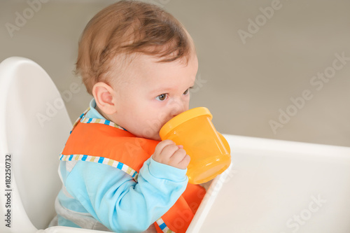 Cute baby drinking water in...
