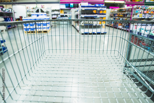 shopping mall consept cart with blurred woman on background