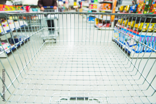 shopping mall consept cart with blurred woman on background