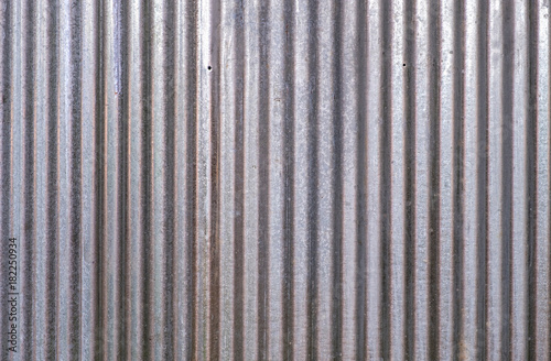Detail of zinc wall surface with nail holes for background.