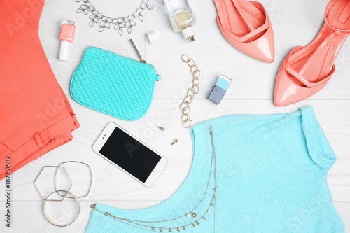 Composition with mint clothes and accessories on light background