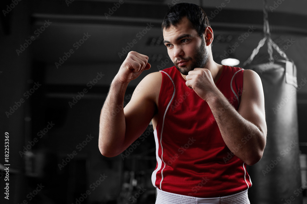 Boxing. Portrait of a boxer on the background of the gym Boxing. Portrait of a boxer on the background of the gym