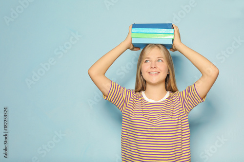 Cute teenager girl with boo...