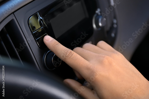 Man tuning car radio, closeup