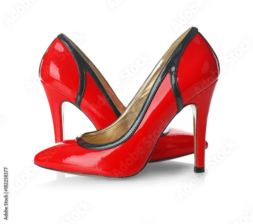 Pair of red female high-heel shoes on white background