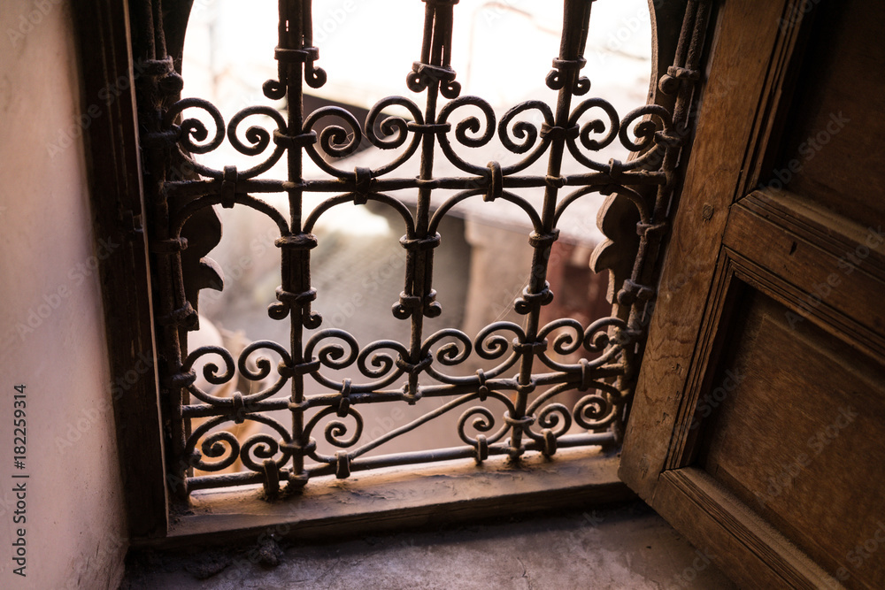 street scene in marrakesh looked through iron window street scene in marrakesh looked through iron window