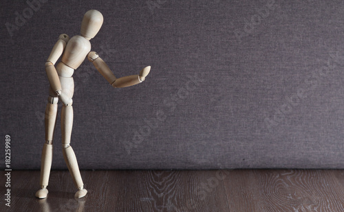 A figurine of a wooden man dreams of a partner in dance. Lonely man. Search for a partner. photo