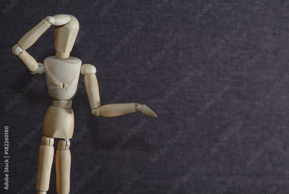 The concept of surprise and misunderstanding of what is happening around. Wooden figure The concept of surprise and misunderstanding of what is happening around. Wooden figure