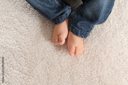 Baby feet on light plaid, closeup © Africa Studio