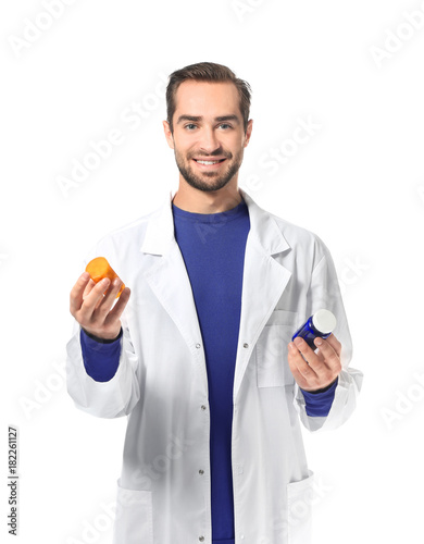 Young pharmacist with pills...