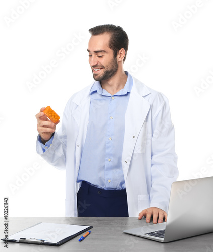 Young pharmacist with pills...