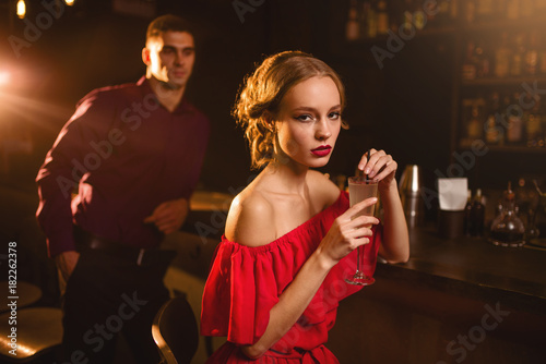 woman with cocktail in hand, flirting