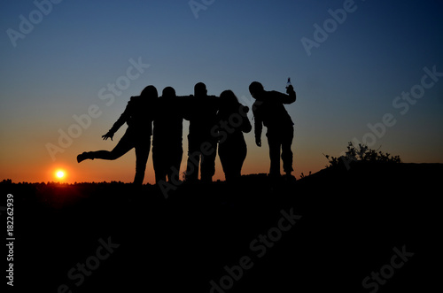 silhouette of people at sunset