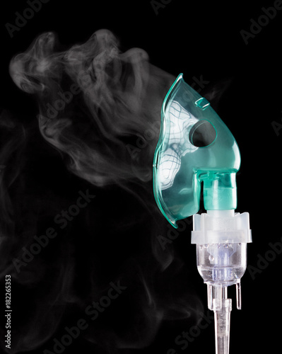 Compressor nebulizer at work, isolated on black