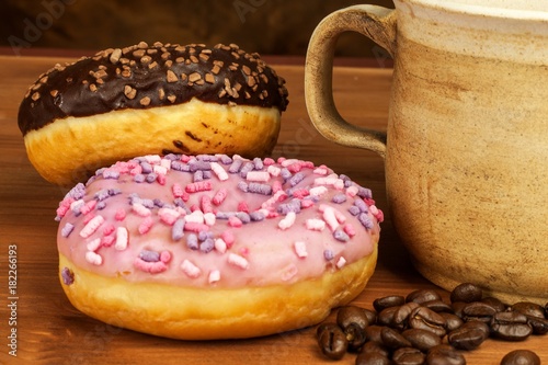 Donuts with coffee. Advertising for the sale of sweets. Sweet breakfast. Risk of obesity.