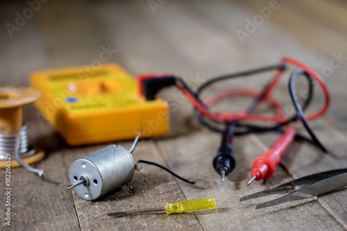 Electronic workshop. Electric meter and soldering iron.