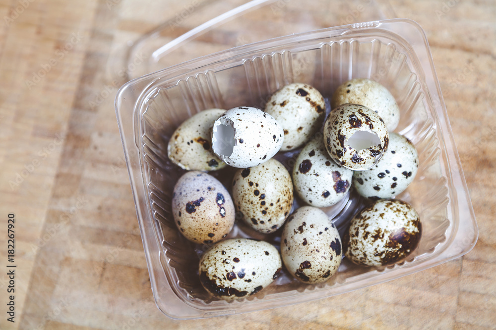 Quail eggs and empty shells lay in transparent box Quail eggs and empty shells lay in transparent box