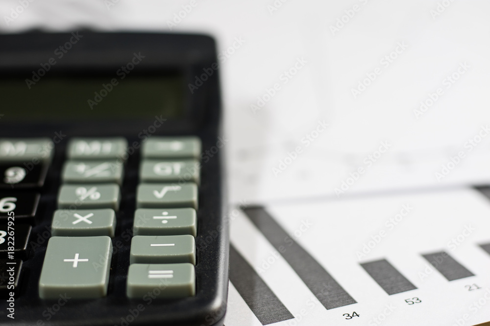Obraz premium Calculations, calculations and economics on paper. Calculator and charts on a wooden table.