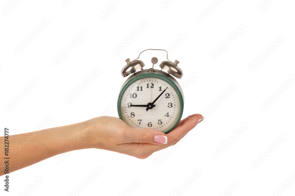 Alarm clock in the woman's hand, isolated Alarm clock in the woman's hand, isolated