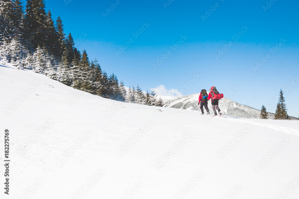 Two climbers are in the mountains.