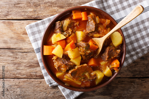 delicious stew estofado with beef and vegetables close-up. Horizontal top view