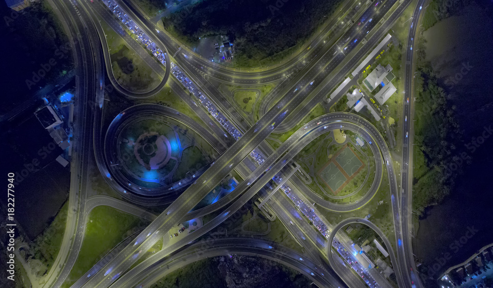Aerial view Road roundabout, Expressway with car lots in the city in Thailand.beautiful Street , downtown,cityscape,Top view. Background,Aerial view city scape Aerial view Road roundabout, Expressway with car lots in the city in Thailand.beautiful Street , downtown,cityscape,Top view. Background,Aerial view city scape