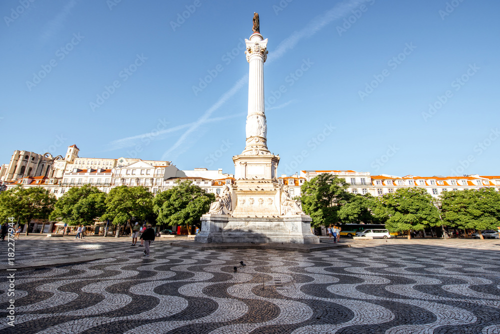 View on the Rossio square with column monument during the sunrise in Lisbon city, Portugal