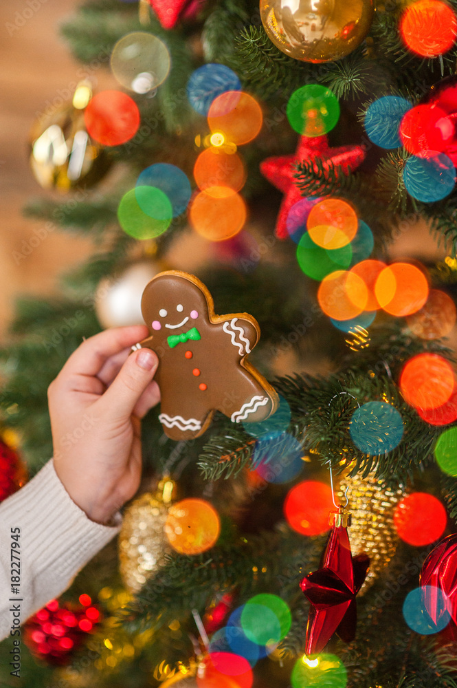 Christmas ginger man near a decorated Christmas tree and festive lights, Christmas card
