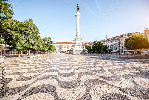 View on the Rossio square with column monument during the sunrise in Lisbon city, Portugal