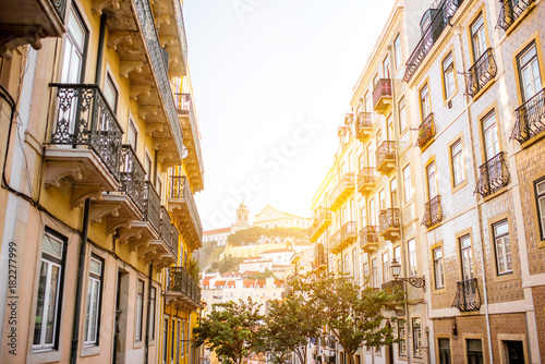 Beautiful street view with beautiful residential buildings in Mouraria district during the morning light in Lisbon city, Portugal
