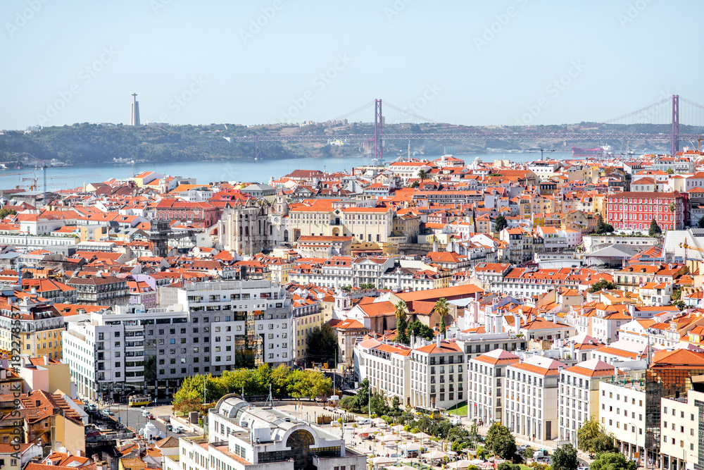 Cityscape view on the Lisbon city with famous bridge during the sunny day in Portugal
