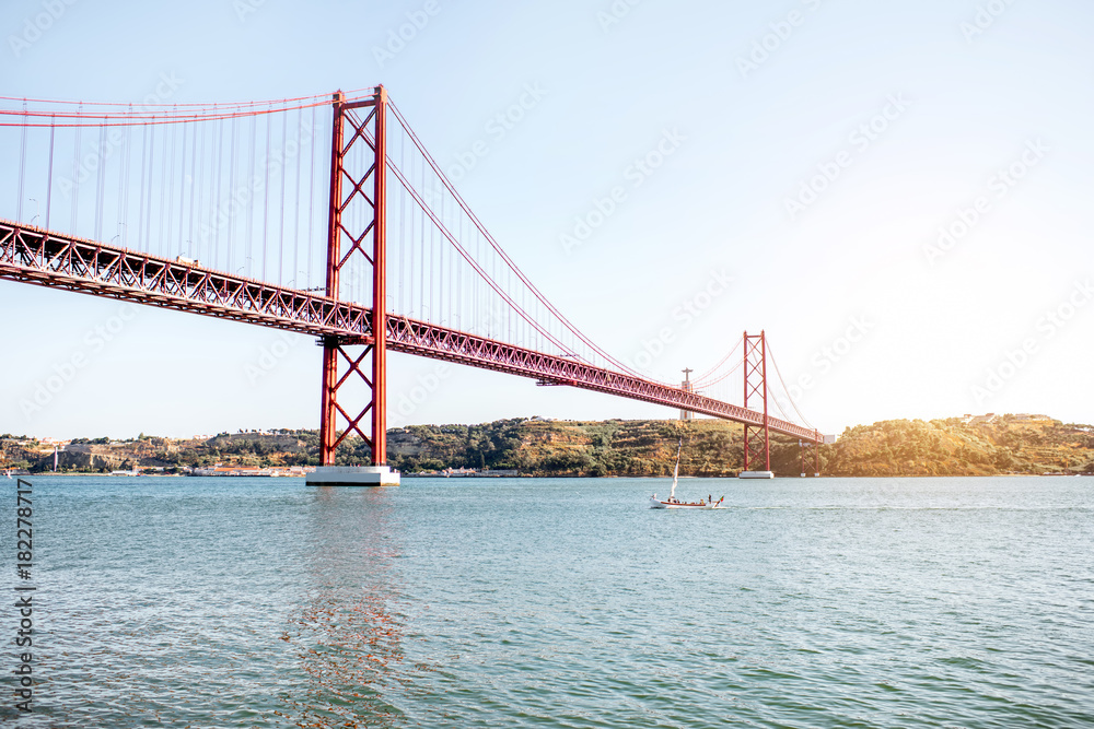 Landscape view on the 25th of April Bridge during the sunset in Lisbon city, Portugal Landscape view on the 25th of April Bridge during the sunset in Lisbon city, Portugal