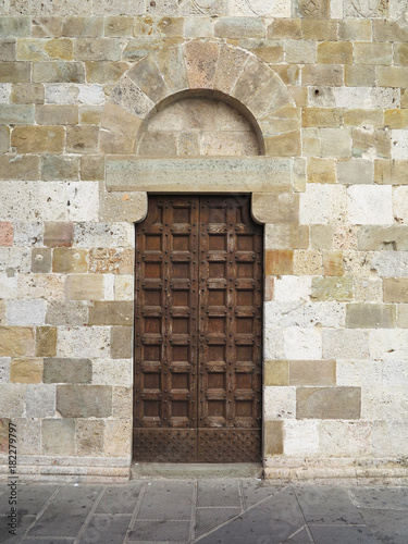 vintage brown wood old door in the medieval sity of Pisa, Italy