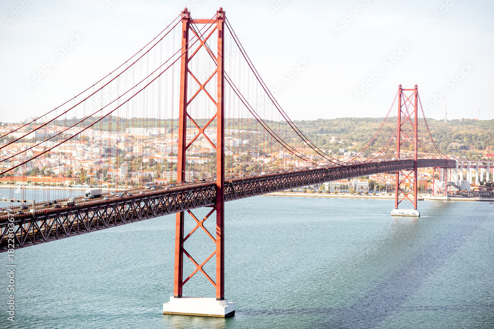 Obraz premium Landscape view on the Tagus river and the famous 25th of April Bridge in Lisbon city, Portugal