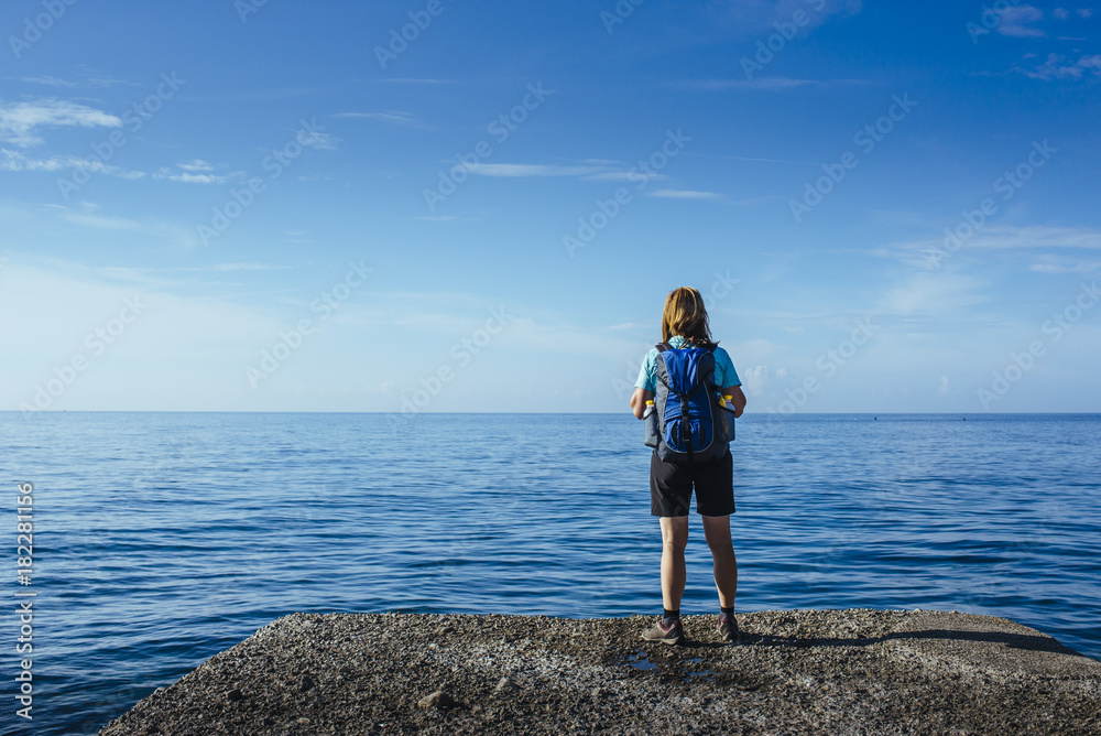 Female hiker with blue daypack on the amalfi coast / Salerno, italy, europe