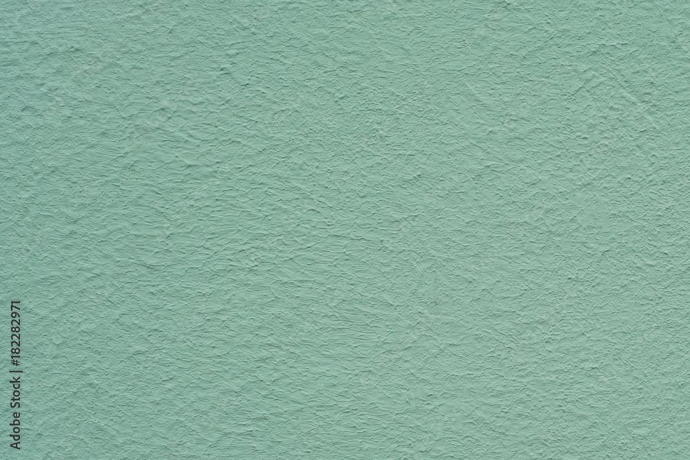 Emerald green painted stucco wall. Background texture.