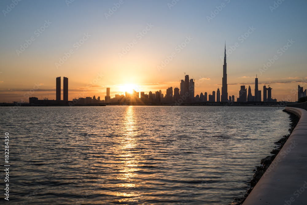 Silhouette of Dubai Downtown at sunset.