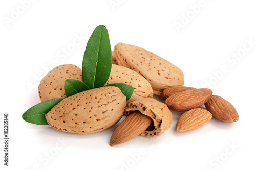 Group of almond nuts with leaves isolated on white background