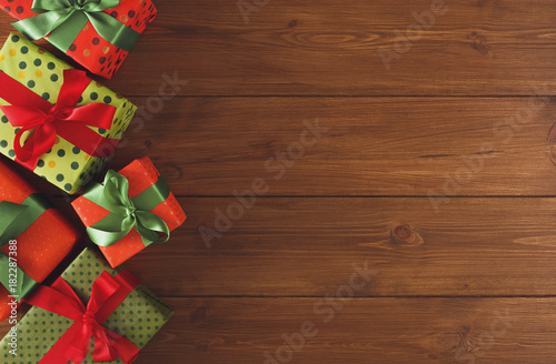 Colorful Christmas present boxes on wooden background