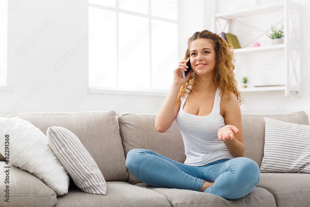 Smiling young girl calling on mobile phone