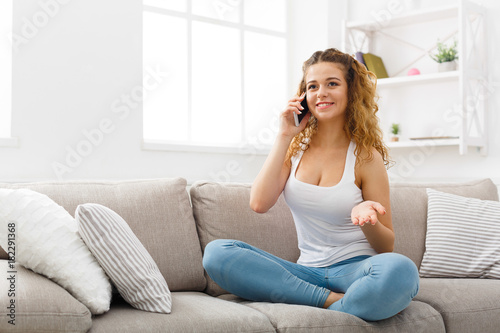 Smiling young girl calling on mobile phone