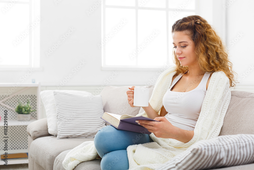 Cozy home. Young thoughtful woman with book Cozy home. Young thoughtful woman with book