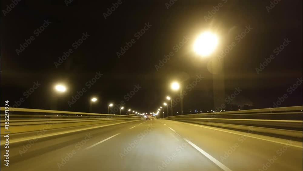 Time lapse of driving a car in the city at night time. POV. Hyper laps in the evening downtown.