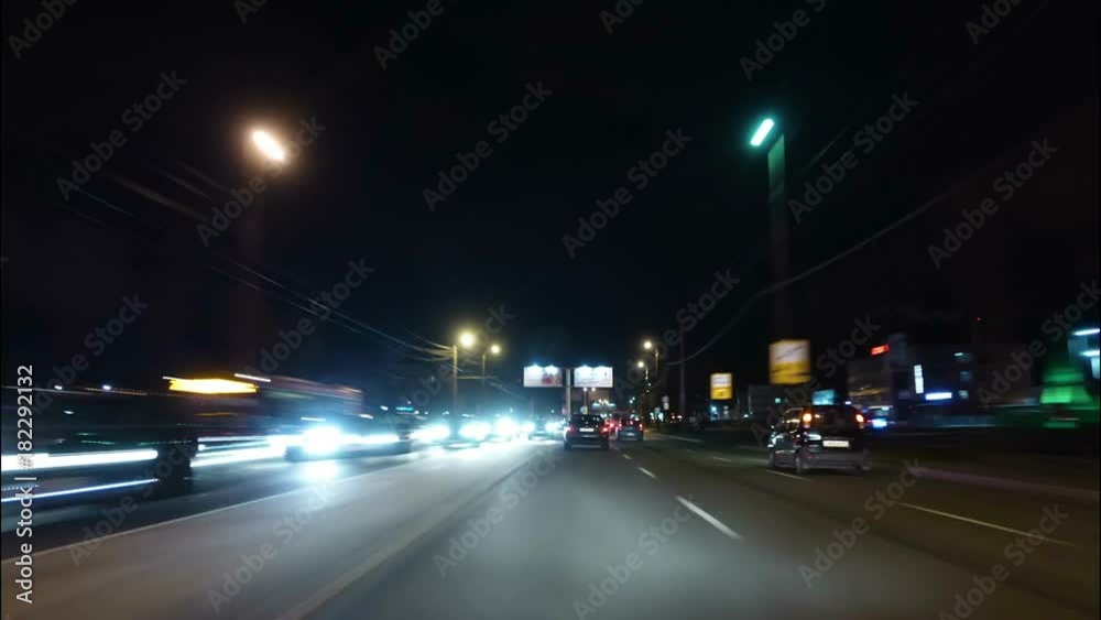 Time lapse of driving a car in the city at night time. POV. Hyper laps in the evening downtown.