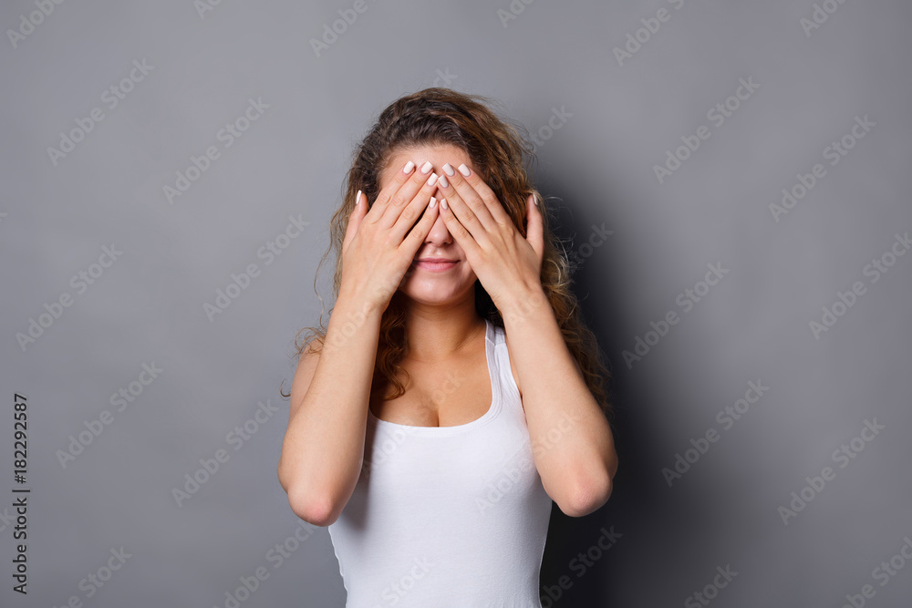 Scared redhead woman covering face with hands Scared redhead woman covering face with hands