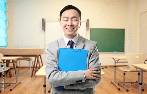 Handsome young Asian teache...