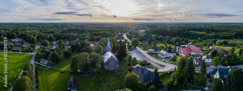 Fototapeta Naklejka Na Ścianę i Meble -  Aerial view of catholic church at sunset. Beautiful sunset at countryside. Panorama.