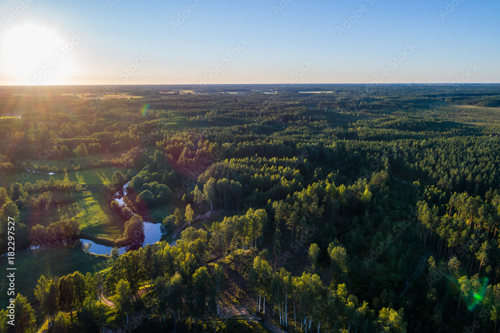 Aerial View. Flying over the beautiful summer rivers at sunset.
