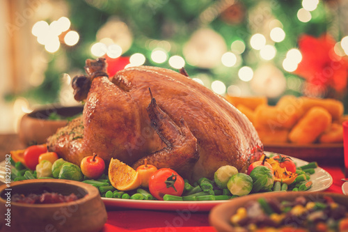 Fotografie Stuffed Christmas turkey dinner served in front of a Christmas tree