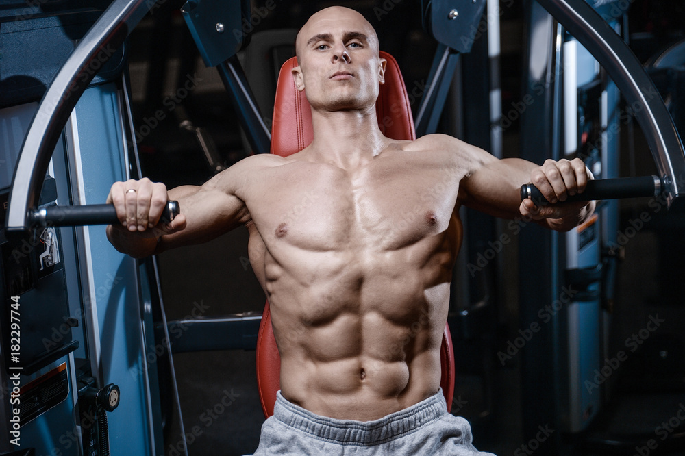 Naklejka premium Brutal strong bodybuilder athletic men pumping up muscles with dumbbells.